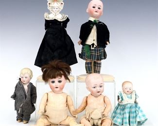 Six antique and vintage Bisque dolls by various makers. Bisque head dolls with painted detail on Bisque, composite and cloth bodies. Some wear and minor damage overall, tartan boy with broken feet. Up to 8" long. ESTIMATE $100-150