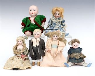 Six antique and vintage Bisque dolls by various makers. Bisque head dolls with painted detail on jointed Bisque and cloth bodies. Some wear and minor damage overall, larger baby with detached legs. Up to 7" long. ESTIMATE $100-150