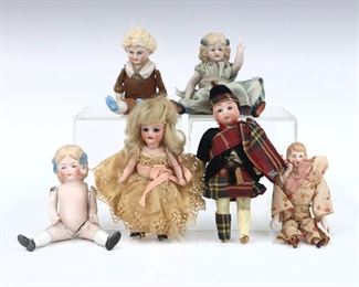Six antique and vintage Bisque dolls by various makers. Bisque head dolls with painted detail on jointed Bisque, composite and cloth bodies. Some wear and minor damage overall, tartan boy with broken feet. Up to 5" long. ESTIMATE $100-150