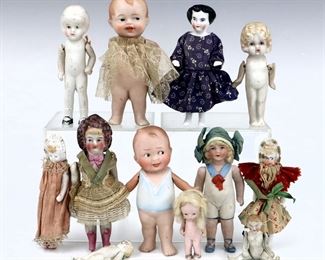 Twelve small antique and vintage dolls by various makers. Eleven Bisque dolls with painted detail on Bisque bodies and one China "frozen Charlotte". Some wear and minor damage overall. Up to 4 1/2" long. ESTIMATE $100-150