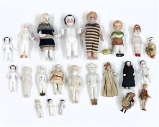 Twenty-two miniature antique and vintage dolls by various makers. Bisque and China dolls with painted detail. Some wear and minor damage overall. Up to 4" long. ESTIMATE $100-150