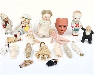 Seventeen miniature antique and vintage doll figures and one doll head by various makers. Bisque and China figures with painted detail. Some wear and minor damage overall. Up to 3" long. ESTIMATE $50-100