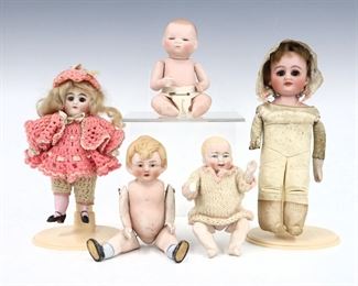 Five antique and vintage dolls by various makers. Includes four full Bisque dolls with painted detail on jointed bodies, and one with Bisque head and sleep eyes on a kid body. One baby signed by "Grace S. Putnam". Some wear and minor damage overall, smallest baby with repairs. Up to 8" long. ESTIMATE $100-150