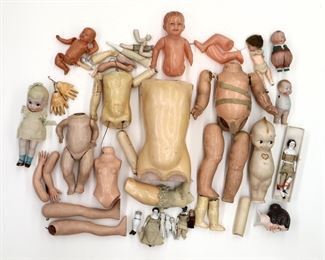 A collection of antique and vintage doll parts. Includes composition doll parts with pieces of Bisque and China figures. Wear and damage overall, as-is.
