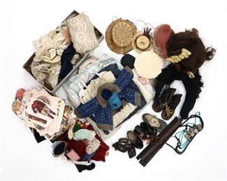 A collection of antique and vintage doll accessories. Includes clothing, wigs, hats, shoes, jewelry, paper dolls, lace and fabric scraps. Wear and damage overall, as-is.