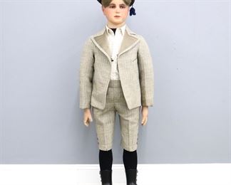 An early 20th century lifesize wax mannequin of a young boy, likely French.  Poured wax head with real Blonde hair, inset glass eyes, hand-painted lips, hair eyebrows and eyelashes on a cloth covered paper mache body with wooden articulated arms, wax hands, and Cast Iron boots.  Wearing a period wool suit with button up shirt and cap, presented in a molded Oak display case with glass sides.  Some wear and minor losses, wear to wax nose and hands, one finger repaired.  Mannequin is 47" high, case is 25 3/4 x 24 1/2 x 50 3/4" high overall.  ESTIMATE $800-1,200
