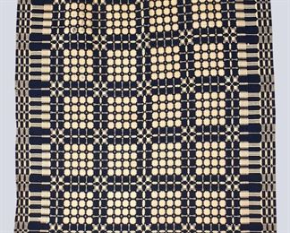 A late 19th century American Jaquard coverlet. One piece construction with "Snowball" design in Blue with "Pine Tree" border. Some wear and losses. Approx. 70 x 88 1/2" long overall. ESTIMATE $100-200