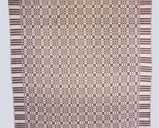 A 19th century American Overshot coverlet. One piece construction with optic design in Blue. Some wear and losses, fading and staining. Approx. 83 x 98" long overall. ESTIMATE $100-200