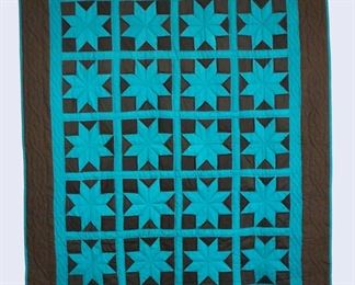 A 20th century Amish quilt. Hand stitched, pieced and quilited with Star design in Teal and Black, with a plain Black backing. Minor wear and losses. Aprox. 68 x 82" long overall. ESTIMATE $100-200