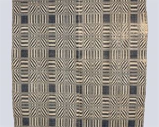 A 19th century American Overshot coverlet. Two piece construction with "Blooming Leaf" design in Blue. Some wear and losses, thinning at edge, 3 x 3" cut to corner. Approx. 64 x 92" long overall. ESTIMATE $100-200