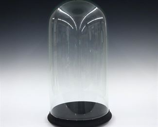 A 20th century Blown Glass doll display dome with painted wood base. Some chips to glass edge. 20" high overall. ESTIMATE $50-75
