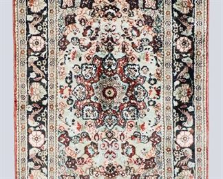 A 2' x 2.9' vintage Indo-Persian Souf Silk rug. Metallic flat weave and Silk pile, multicolor floral and bird design with central medallion on a Black field. Some wear and losses to edges. ESTIMATE $200-300