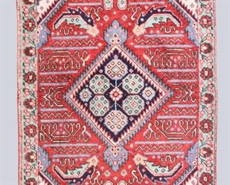 A 2.6 x 4.4' vintage Caucasian rug. Multicolor floral design with central geometric medallion on a Red field. Some wear and discoloration, losses to fringe. ESTIMATE $100-200