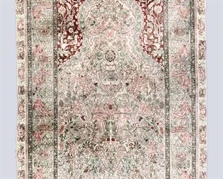 A 3' x 5' vintage Indo-Persian Silk prayer rug. Multicolor Tree of Life design on an Ivory/Green field. Some wear, losses to fringe. ESTIMATE $300-500