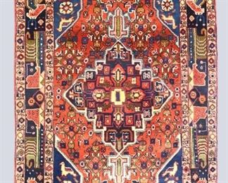A 3.1 x 5' vintage Caucasian rug. Multicolor floral design with animals and central medallion on a Red field. Some wear, a few stains to fringe. ESTIMATE $200-400