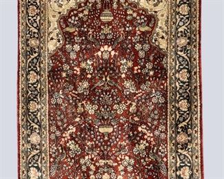 A 2.6 x 4' vintage Sino-Persian Silk prayer rug by Lara Nathan. Multicolor floral and bird design on a Brick Red field. Some wear and discoloration. ESTIMATE $200-300