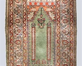 A 3 x 4.3' vintage Turkish Silk and Wool prayer rug. Multicolor floral and pilar design on an Ivory field. Some wear and discoloration, minor losses. ESTIMATE $100-200