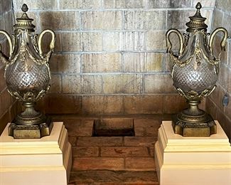 #29. $900. Pair of Baccarat gilt/glass Urns, 22"Hx10.5"x8", and wood bases, 12"x12"x9H.