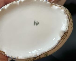 #17. $70. Lot of (4): German Porcelain Figure and Box, French Porcelain Children Figure & Gilt Ruby Decanter (chipped at rim).