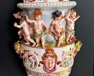 #60- $1,800 Monumental Pair of Capodimonte Covered Figural Urns, 30"Hx13"W. One finial is damaged...we have the pieces to be glued.