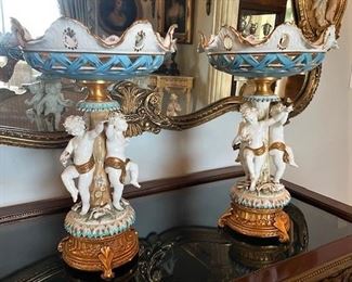 #103- $400 Pair of Italian Porcelain Tazzas with cupids around stem, signed Tiche, 18"Hx12"