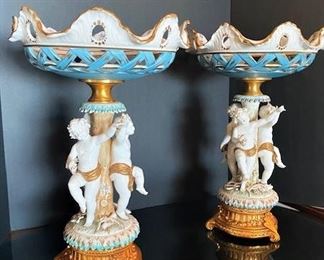 #103- $400 Pair of Italian Porcelain Tazzas with cupids around stem, signed Tiche, 18"Hx12"