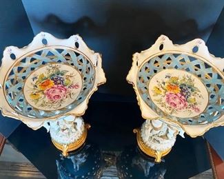 #103- $400 Pair of Italian Porcelain Tazzas with cupids around stem, signed Tiche, 18"Hx12"
