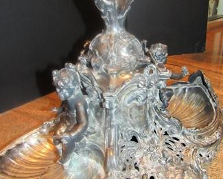 #107- $1000 19th century Silver Plated Epergne with trumpet vase and glass center, flanked by two putti and shell cups. 2'w X 32T