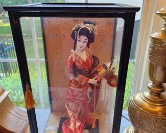 "Yaegakihime"  This doll portrays a princess in the ildSamorai days. She is seen handling a helmet to her husband who is about to leave for the battle front.