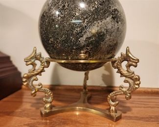 Brass dragon holder with a marble ball