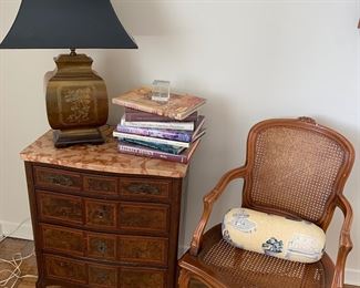 Marble top French commode, art books, Asian brass lamp