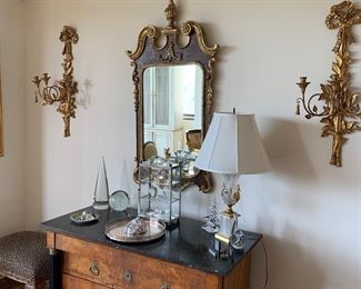 The sconces on either side of the mirror are not available.