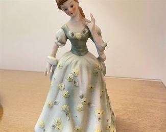Woman figurine in yellow daisy dress,  $8