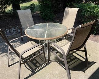 4 outdoor chairs,  $50.  Glass top table,  $25