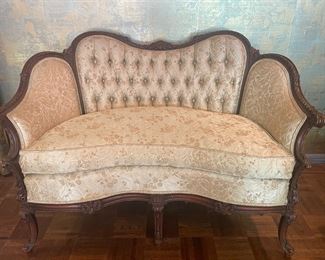 French Love Seat with tufted seat back, carved hardwood frame with cabriole legs. Upholstered in an ivory matelasse.