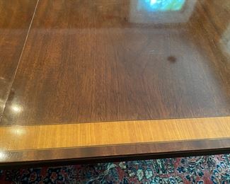 English banded mahogany dining table                                        29"h x 72"x 48" d long   plus two 24" leaves 