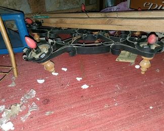 Metal Light fixture still affixed to a piece of wood 