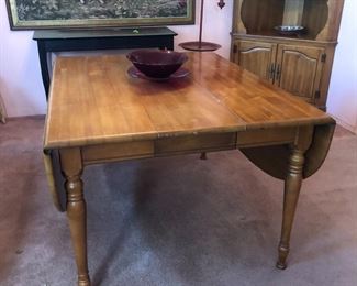 Expandable dining table with leaf and flaps