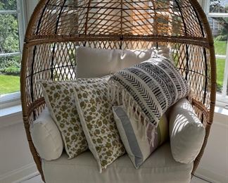 Wicker Egg Chair & Assorted Throw Pillows.