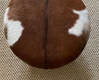 Cowhide Upholstered Ottoman. Measures 24" D x 16" H. Photo 1 of 2.
