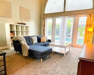 IKEA Modular sofa in Blue 
White Coastal coffee table with display drawer 
White IKEA Kallax cubbies 