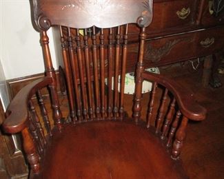 Vintage Rocking chair with design on top back. Pretty lines and comfy.