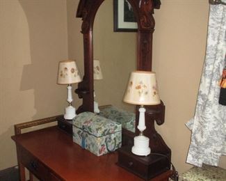 Victorian walnut mirror sits comfortably on this side table.
