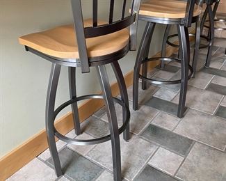 Four metal and wood counter stools