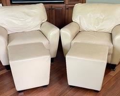 Pair of Leather Chairs with Ottomans by American Leather. The chairs measure 37 x 37 x 32 inches and the ottomans measure 18 x 18 x 18 inches. There is some light wear. 