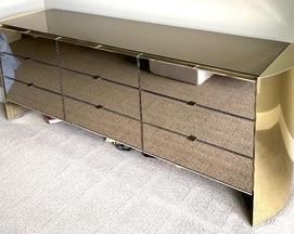 Gold and Bronze Toned 9 Drawer Dresser that measures 80 x 21 x 30 inches. There is some wear including scratch marks