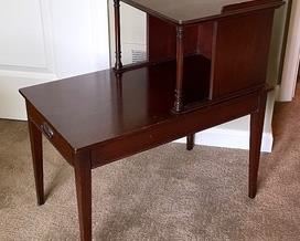 Vintage Genuine Mahogany Accent Table that measures 25 x 15 x 27 inches. There is some wear including small chips and scratch marks. 