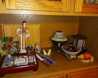 Oriental themed dolls and decorations, waterfall feature table top