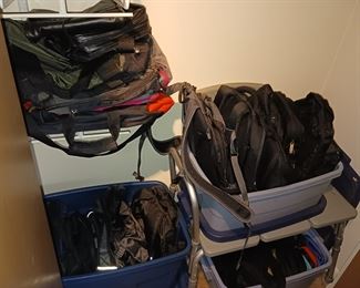 Several totes and backpacks computer bags