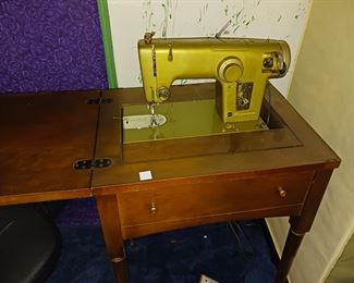 Vintage Sears Kenmore sewing machine in sewing table
